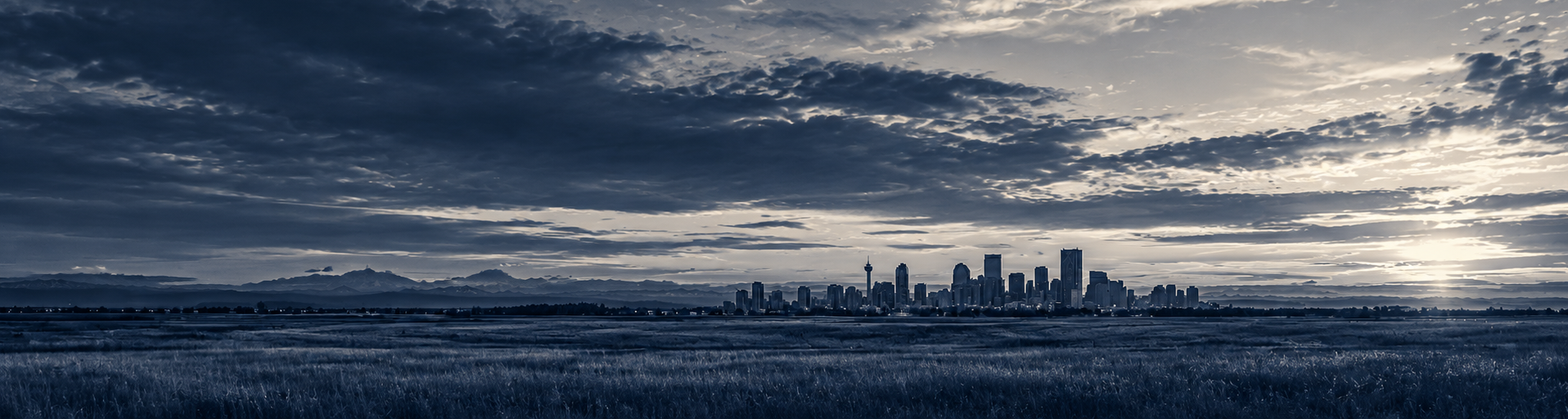 The Calgary skyline beneath an overcast prairie sky