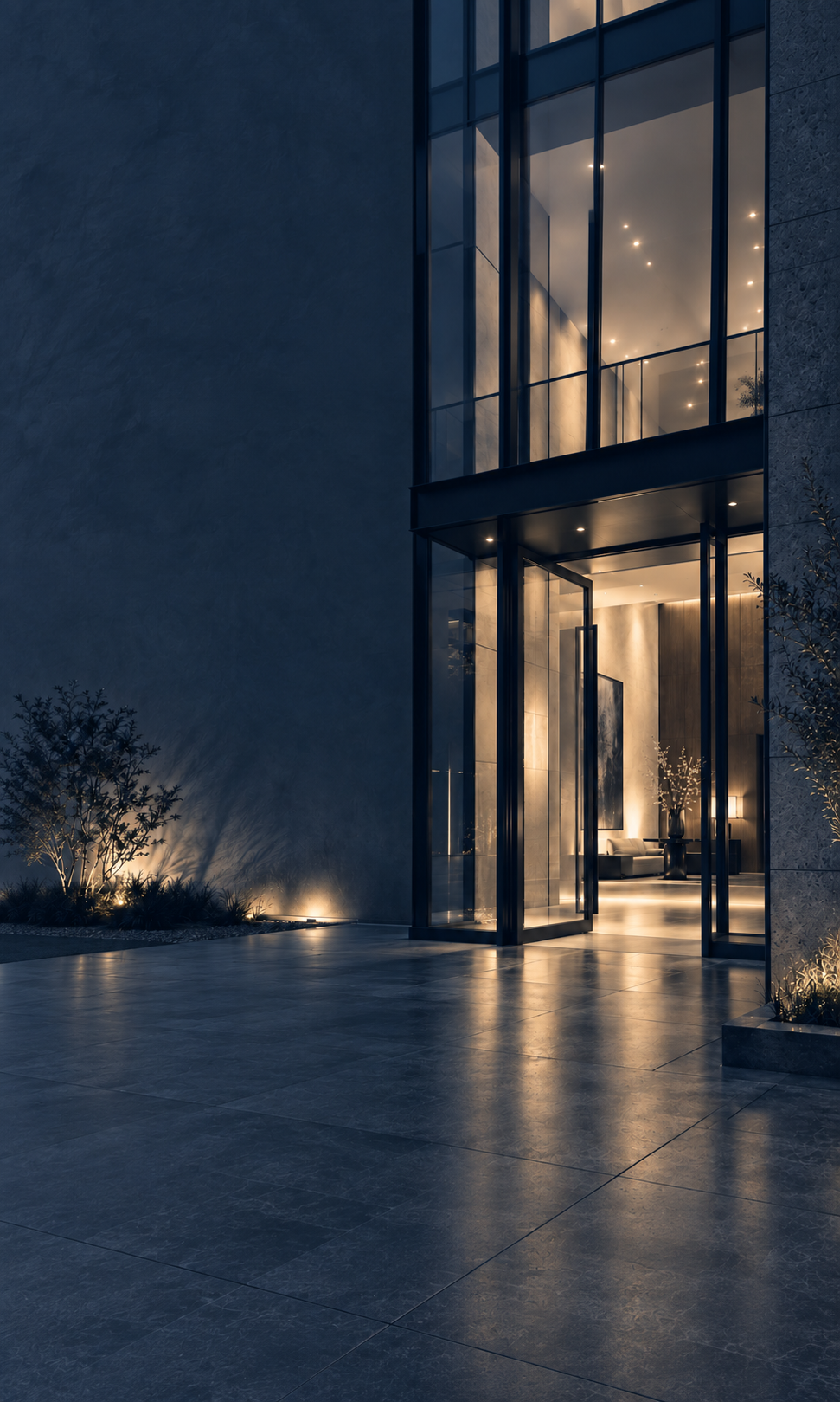 A softly lit modern building entrance at dusk, doors open